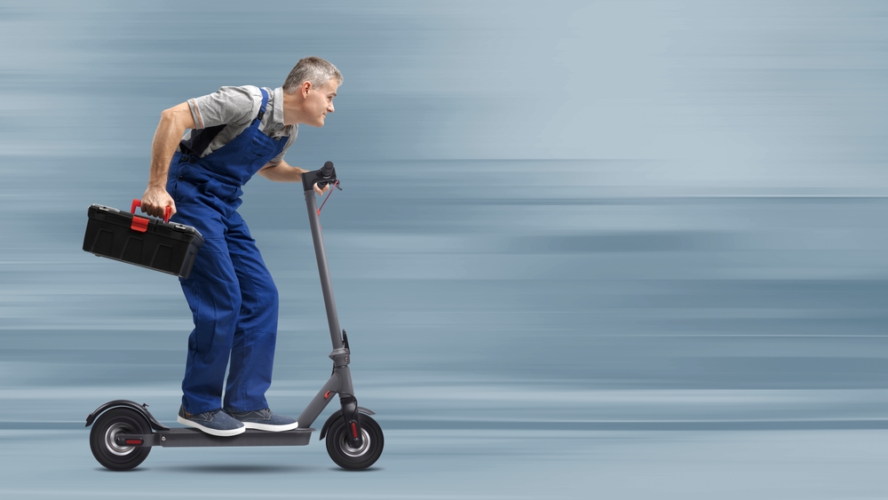 Professional fast repairman riding an electric scooter and holding a toolbox, express repair service concept
