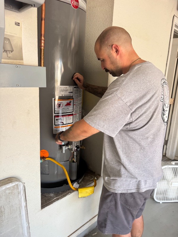 plumber servicing gas water heater