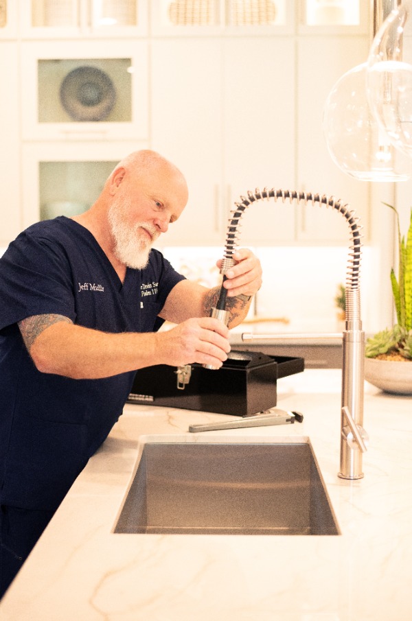 plumber-installing-kitchen-faucet-spray-head plumber installing kitchen faucet spray head